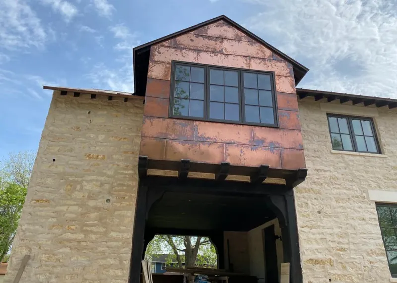 Copper metal panel facade on a stone building for Roof Repair in Grapevine