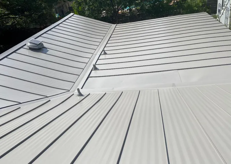 Solar attic fan installed on a metal roof for Roof Ventilation in Grapevine